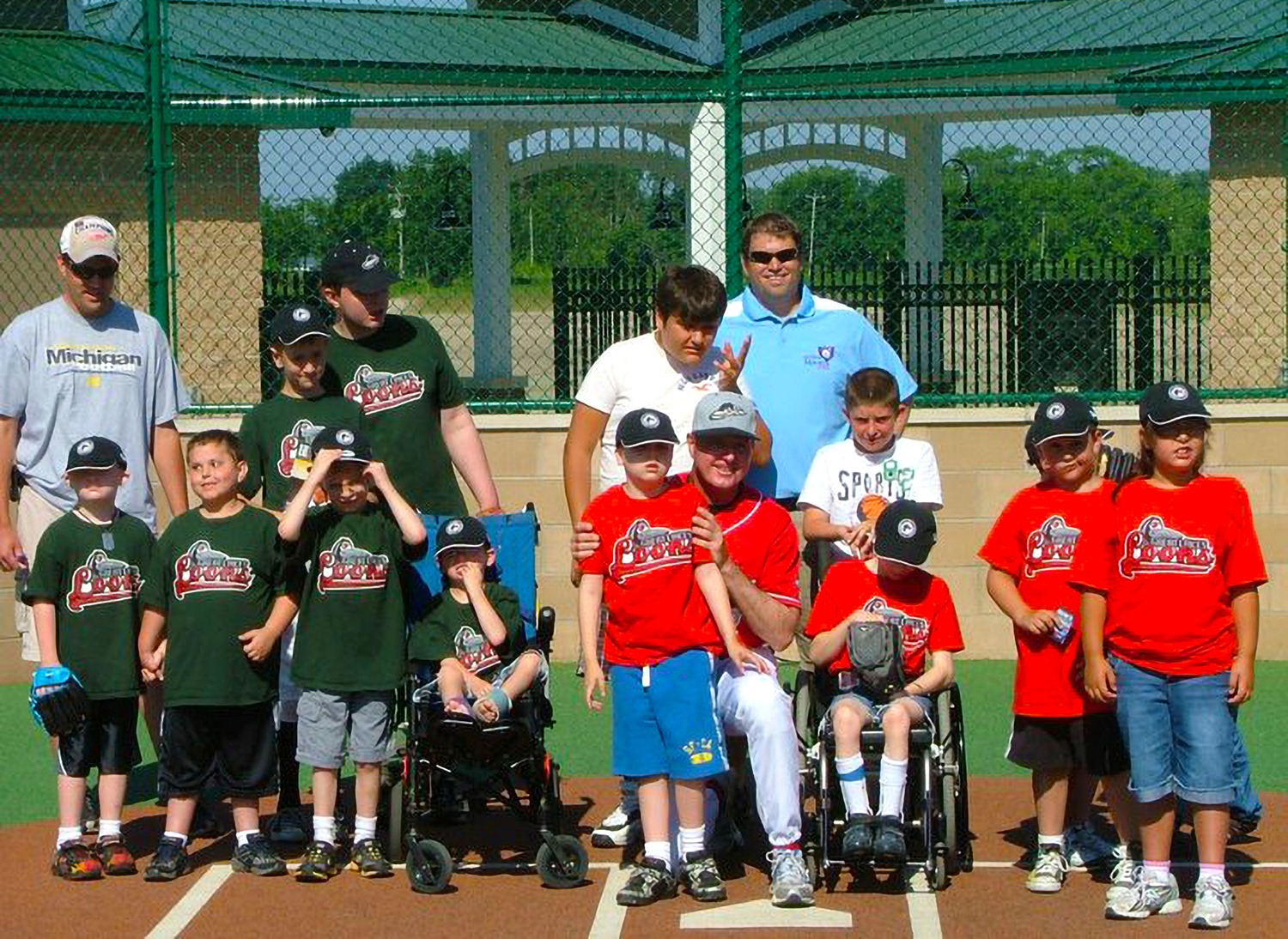 Midland Miracle Field Baseball Event with teams posing for photo wearing Great Lakes Loons shirts as jerseys.