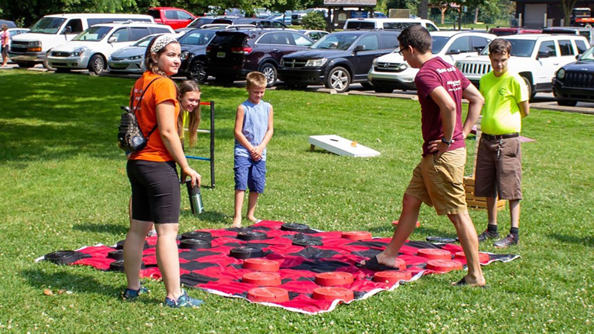 youth playing giant checkers at a Disability Network Mid-Michigan sponsored ADA free community picnic